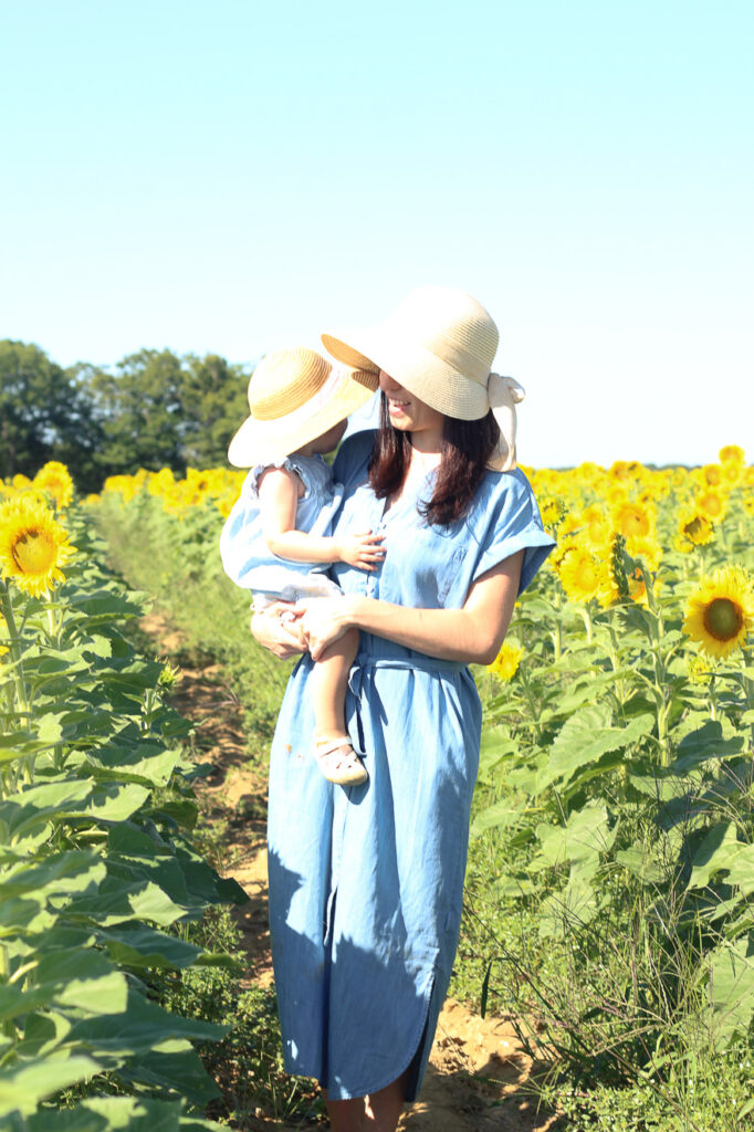 holding Austyn in the sunflower fields